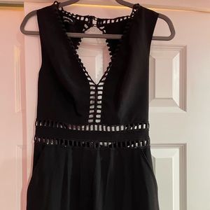 Bebe, size 8 black slim jumpsuit with cut outs